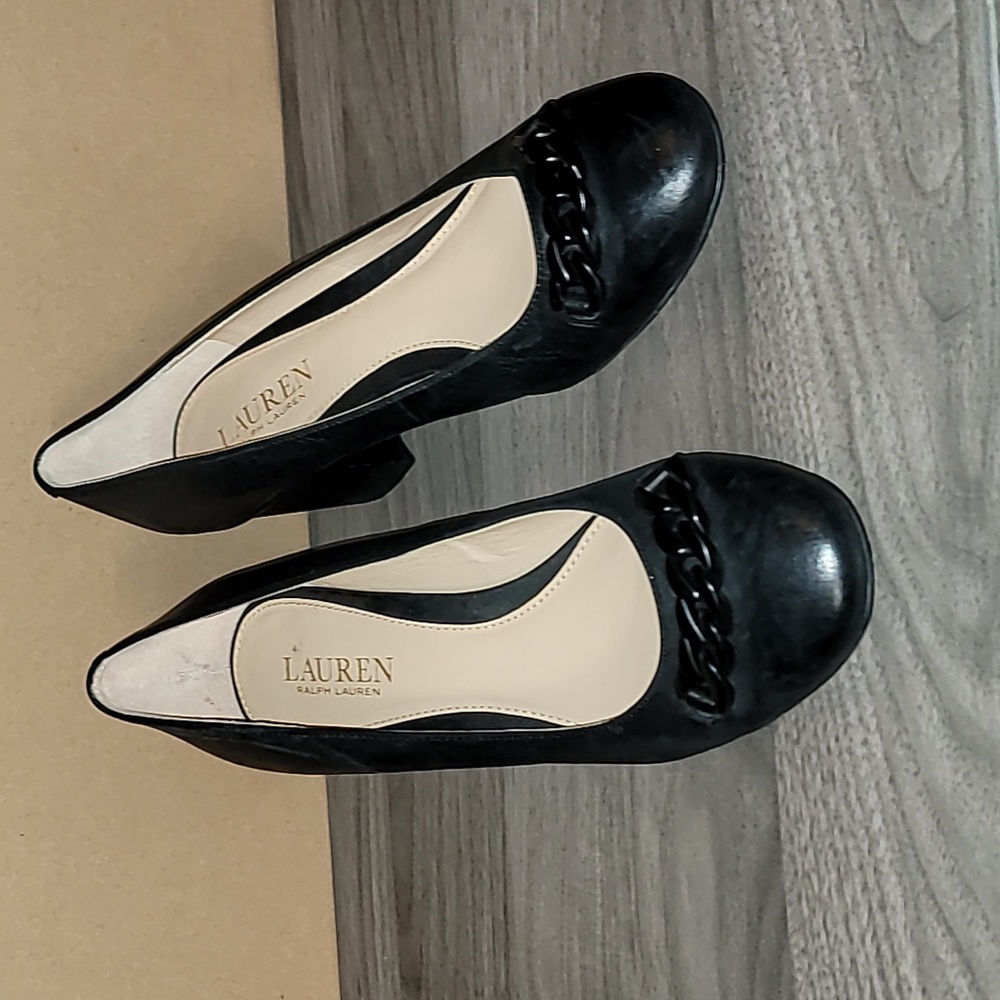 Black round toe pump with chain detail.